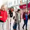 5 students walking down Humber street while Talking.