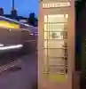 cream kcom telephone box from hull at night time