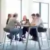 Students sitting around a table in the Business Lounge