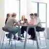 Students sitting around a table in the Business Lounge