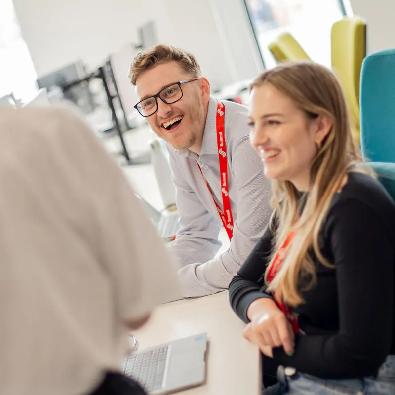 University staff at a desk working on a project