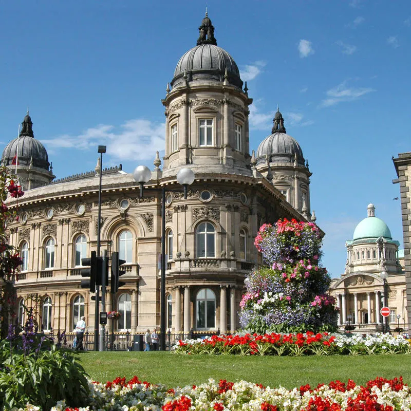 Hull Maritime Musuem in the sunshine with flowers in bloom in the foreground