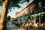groups of drinkers sat outside bars in the sunsghine on Hull's trendy Princes Avenue