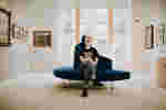 A students sits in a gallery space