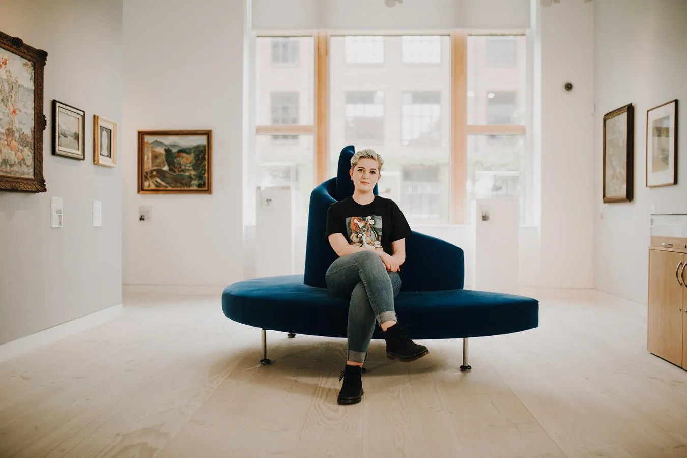 A students sits in a gallery space
