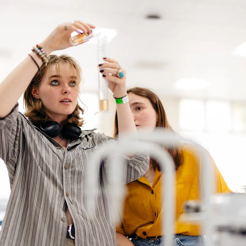 Students measuring liquid in a lab