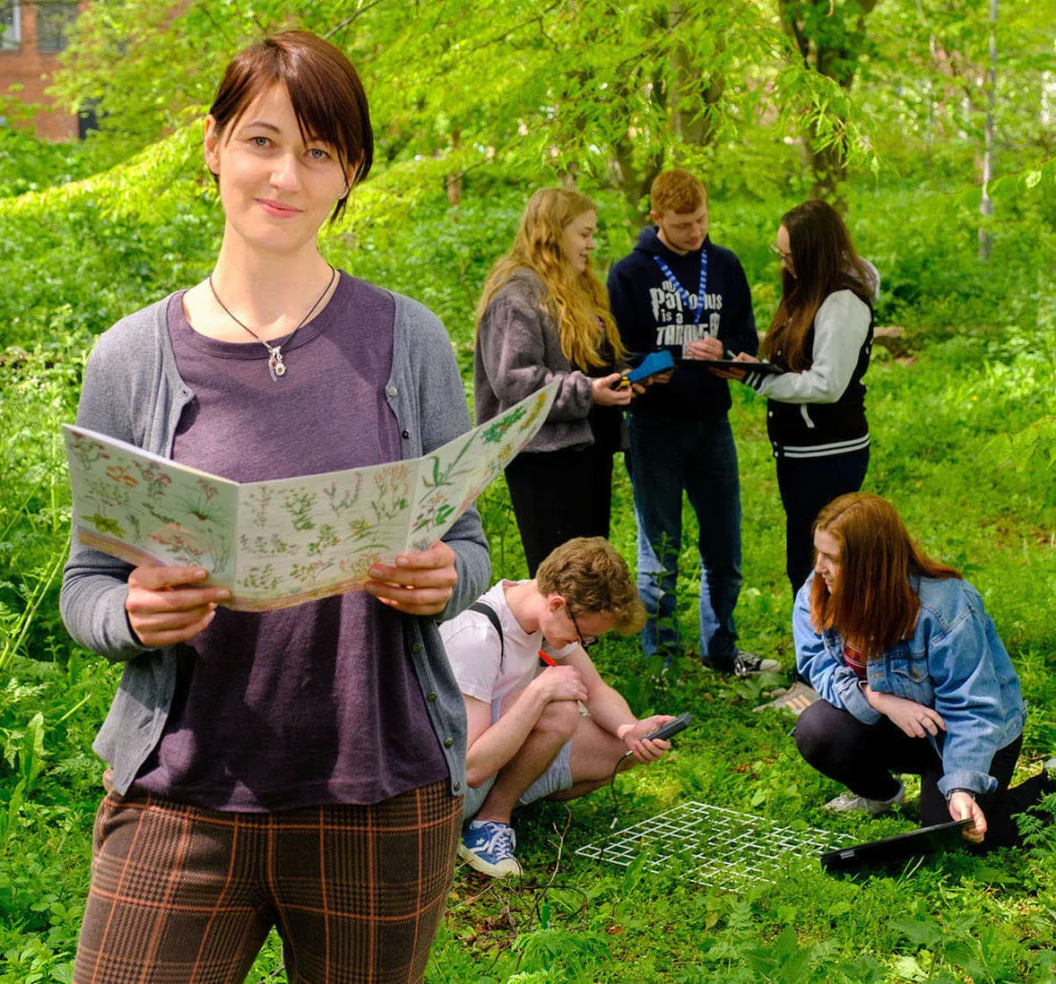 A group of Environmental Science students collecting samples in a wood