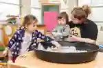 Two children with a teacher
