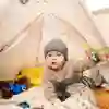 Toddler playing in a teepee