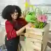 Student watering plants in the Interactive Education Suite