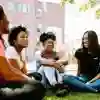 International Student Ambassadors Sat Chatting on Grass