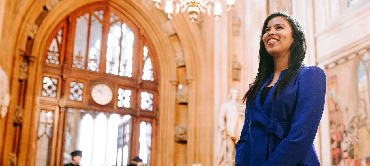 A smiling Politics student inside the Houses of Parliament while on placement at Westminster.