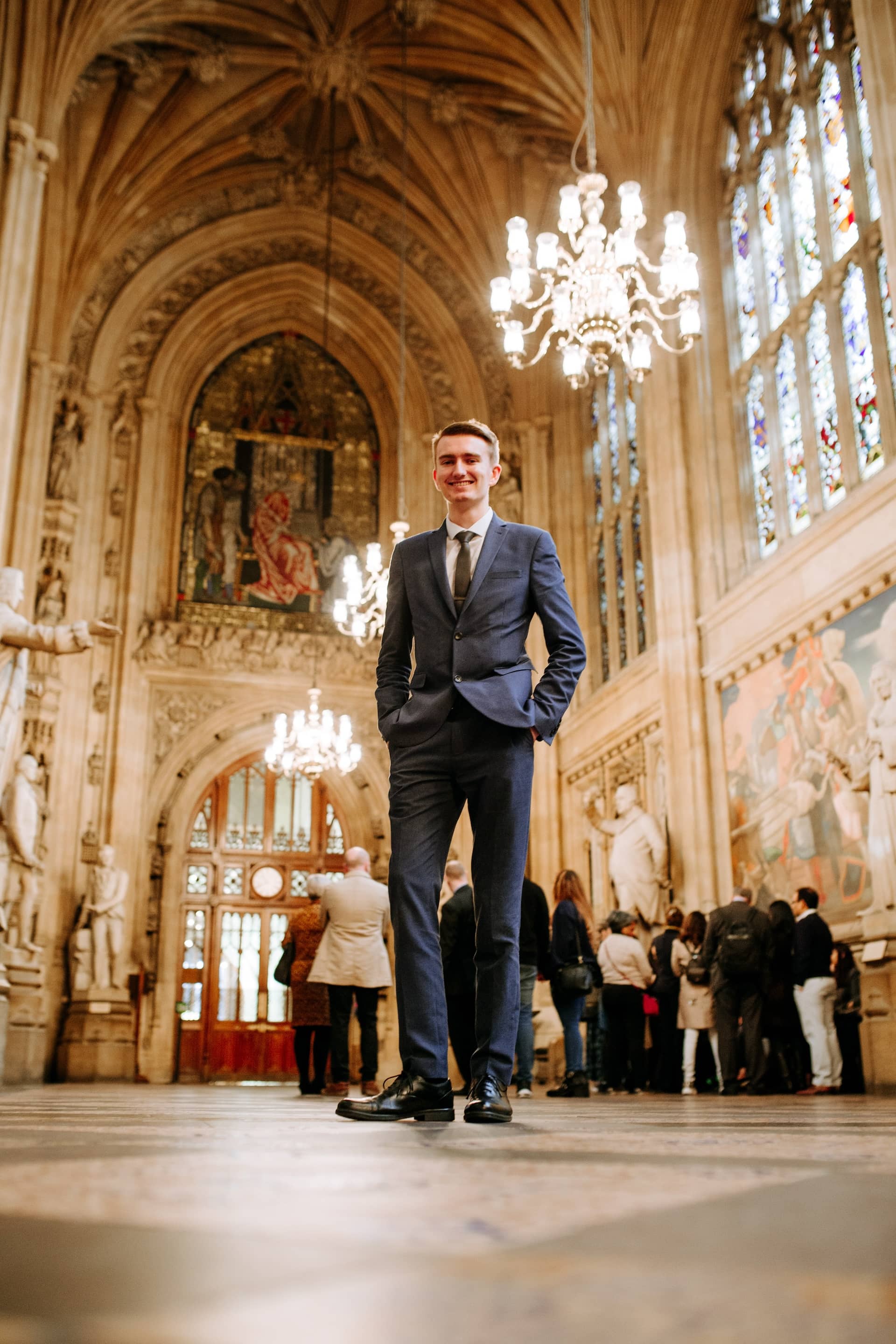 A Hull student in a smart suit standing inside the Houses of Parliament while on placement in Westminster