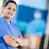 An ODP student in surgical scrubs standing outside the Allam medical building