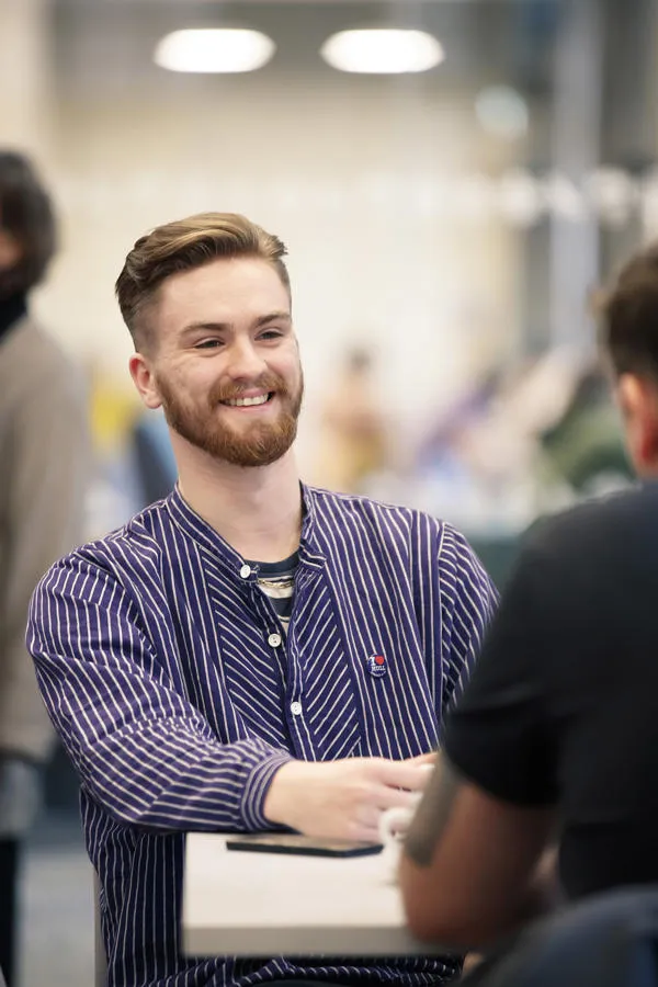 Joshua having a conversation on campus
