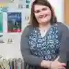 A smiling schoolteacher in a classroom