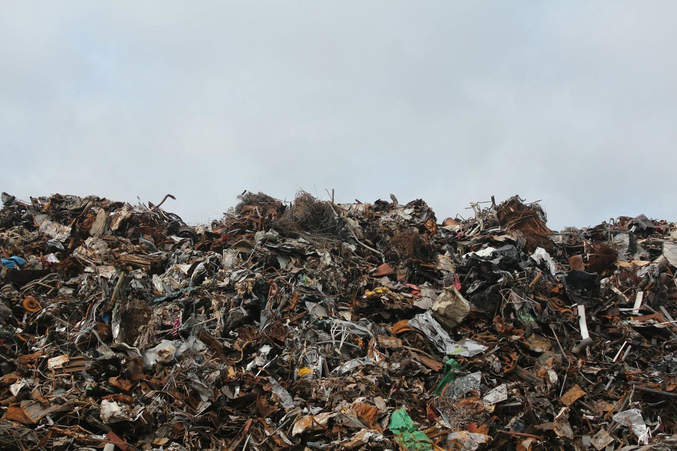 A landfill site against a grey sky
