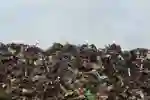 A landfill site against a grey sky