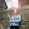 A Criminology student leaning against a wall outside Hull Prison