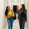 Two students walking through the Legal Advice Centre corridor