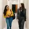 Two students walking down the Legal Advice Centre Corridor