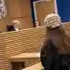 A law student taking part in a trial in the mock courtroom