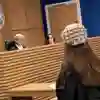 A law student taking part in a trial in the mock courtroom