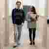 Two students walking down a corridor in the Legal Advice Centre