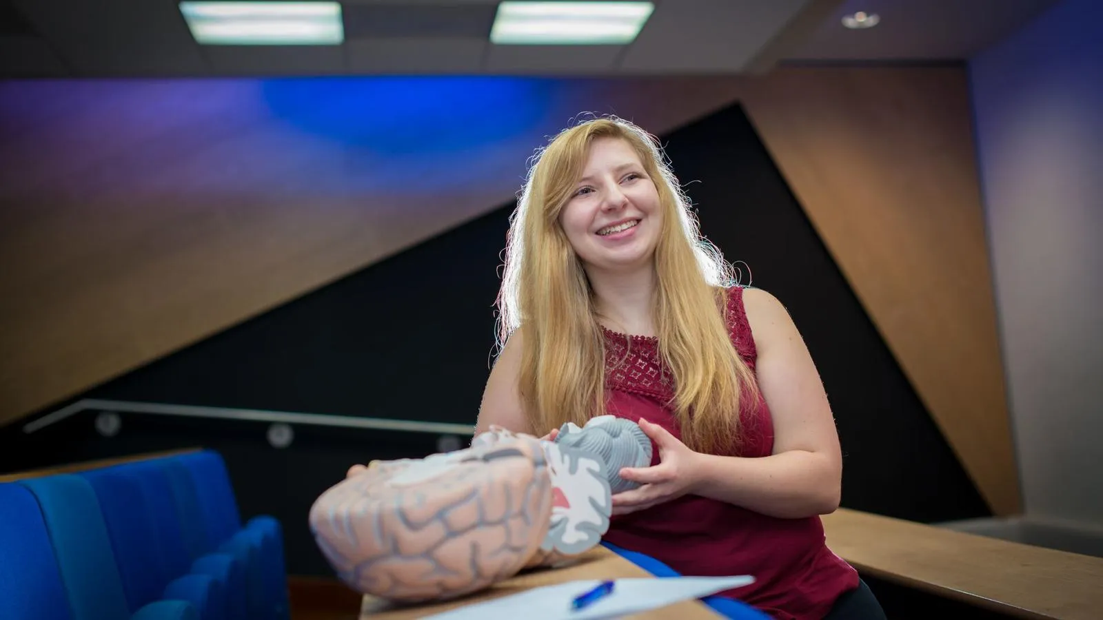 Student sat at a table with a model brain