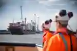 Workers watching a carco ship at the Port of Hull. 