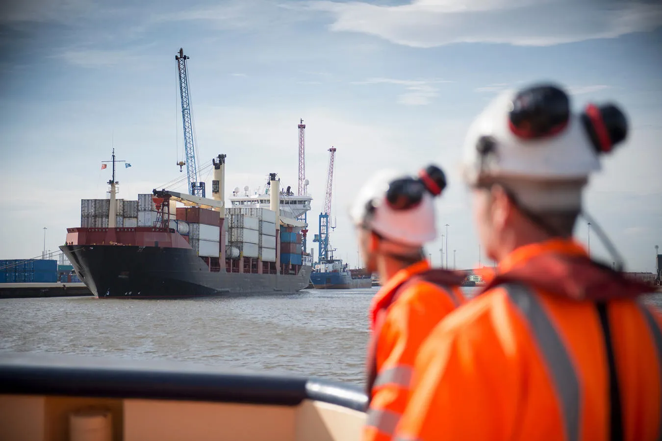 Workers watching a carco ship at the Port of Hull. 