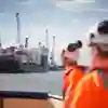 Workers watching a carco ship at the Port of Hull.