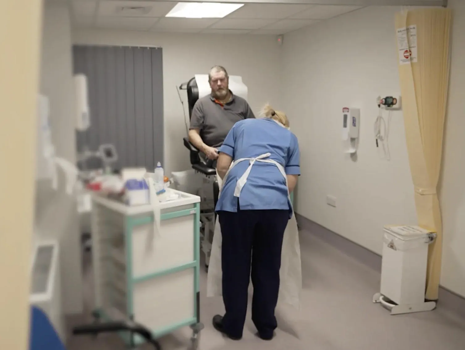 A patient receiving care from a nurse in hospital