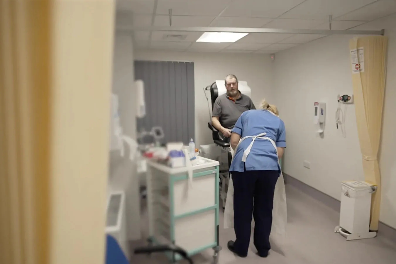 A patient receiving care from a nurse in hospital