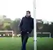 Mark Chapman leans agains a goalpost in a field