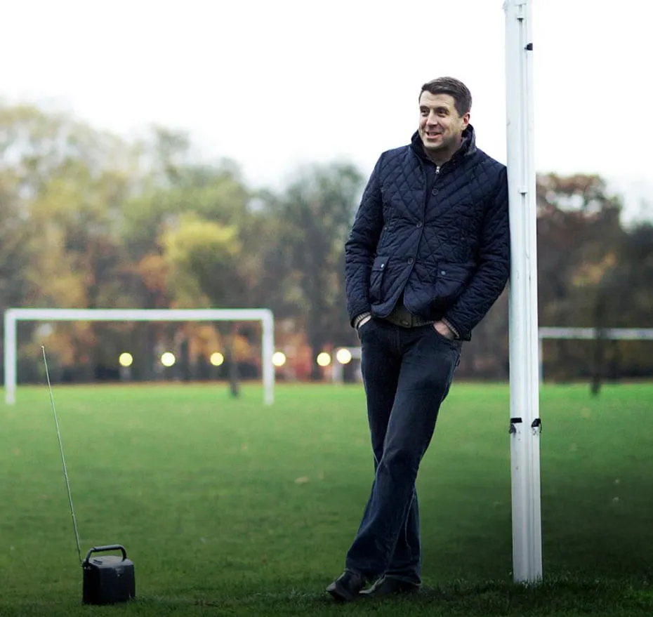 Mark Chapman leans agains a goalpost in a field