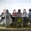 a group of students sat at a large table in a library study room