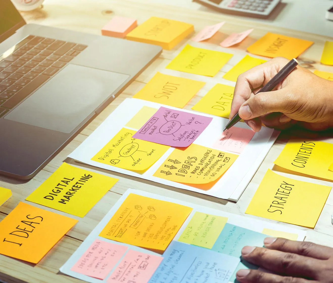 A marketing student writes on post-it notes