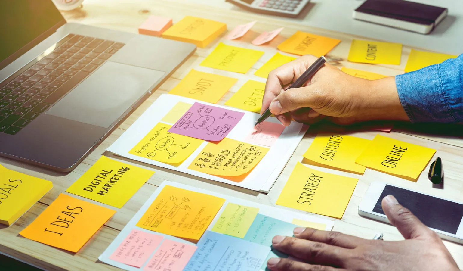 A marketing student writes on post-it notes