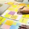 A marketing student writes on post-it notes
