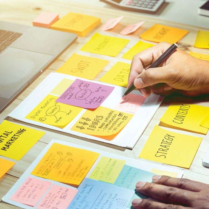 A marketing student writes on post-it notes