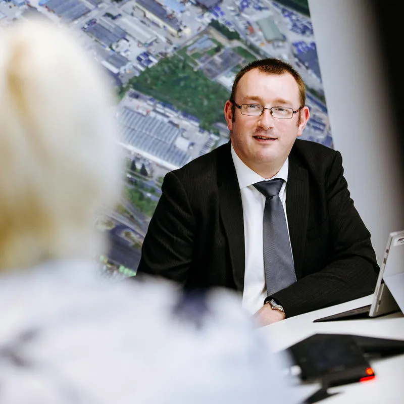 Man sits at a desk with an open laptop