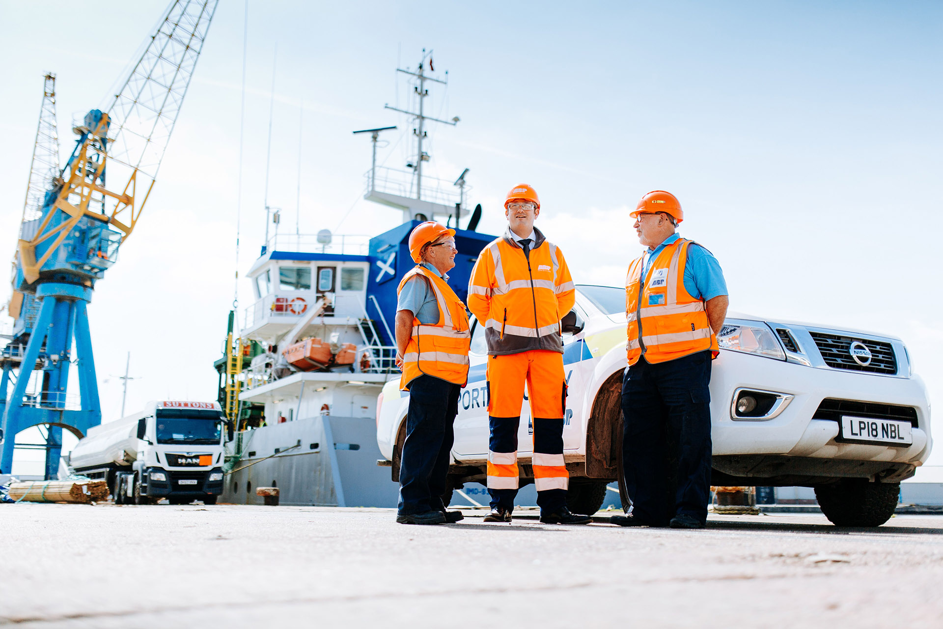 Three people in high-vis clothing