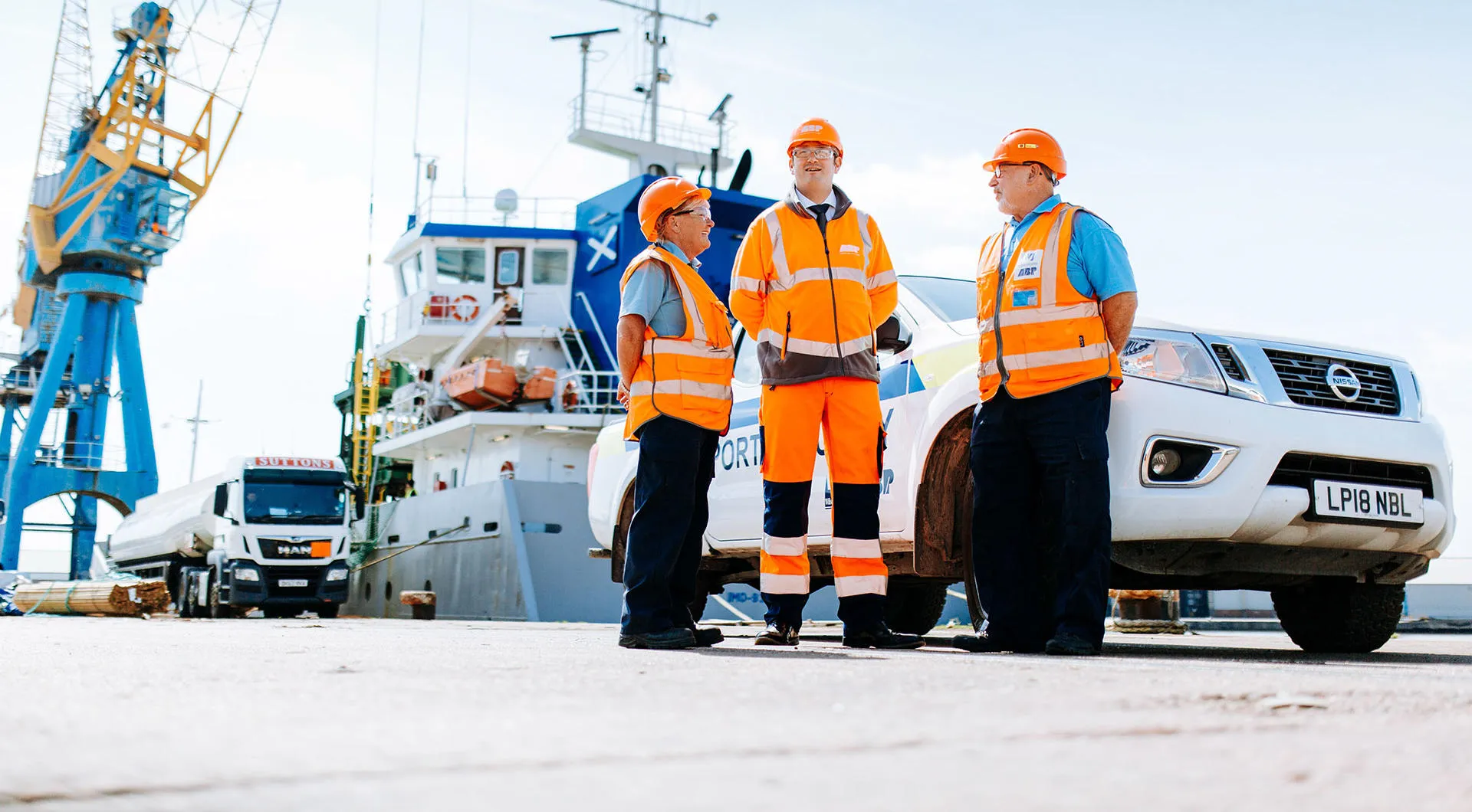 Three people in high-vis clothing