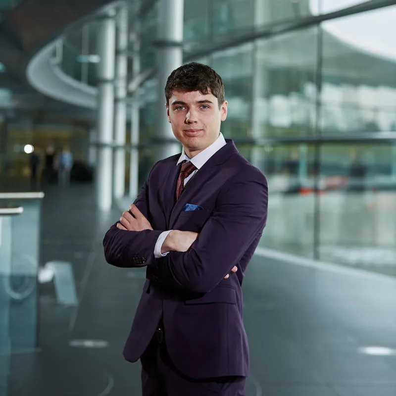 Mechanical engineering student wearing a suit at McLaren headquarters