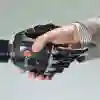 Robotic hand shaking a male human hand