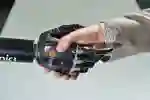 A man in a suit shaking hands with a robotic hand