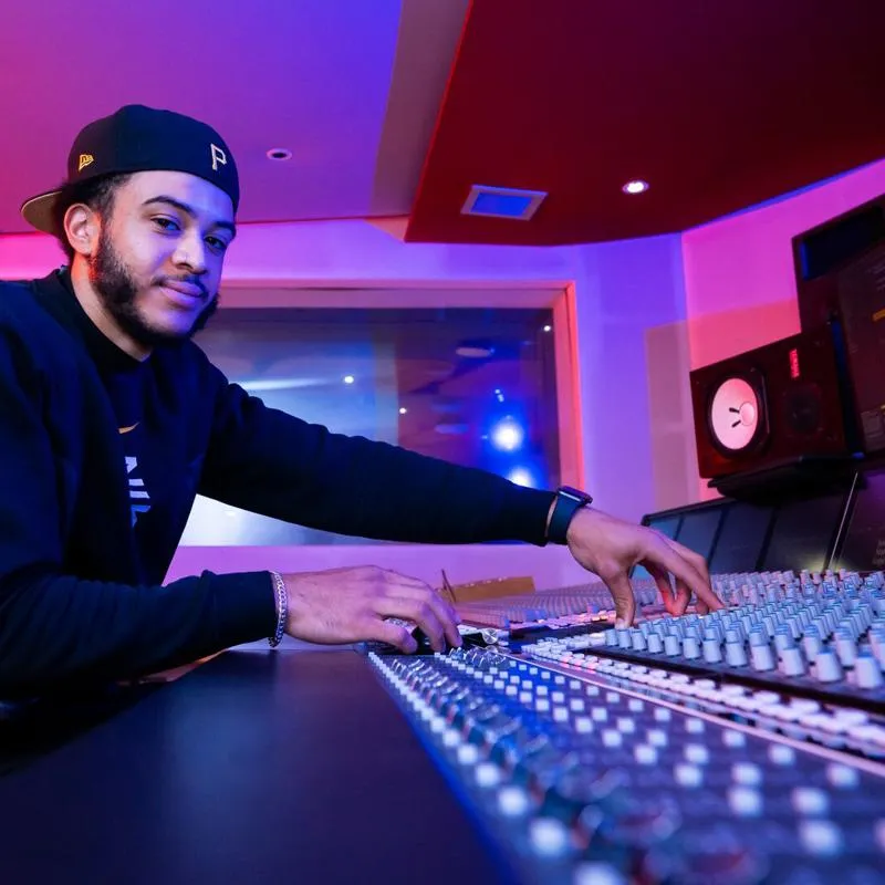 A student on the mixing desk
