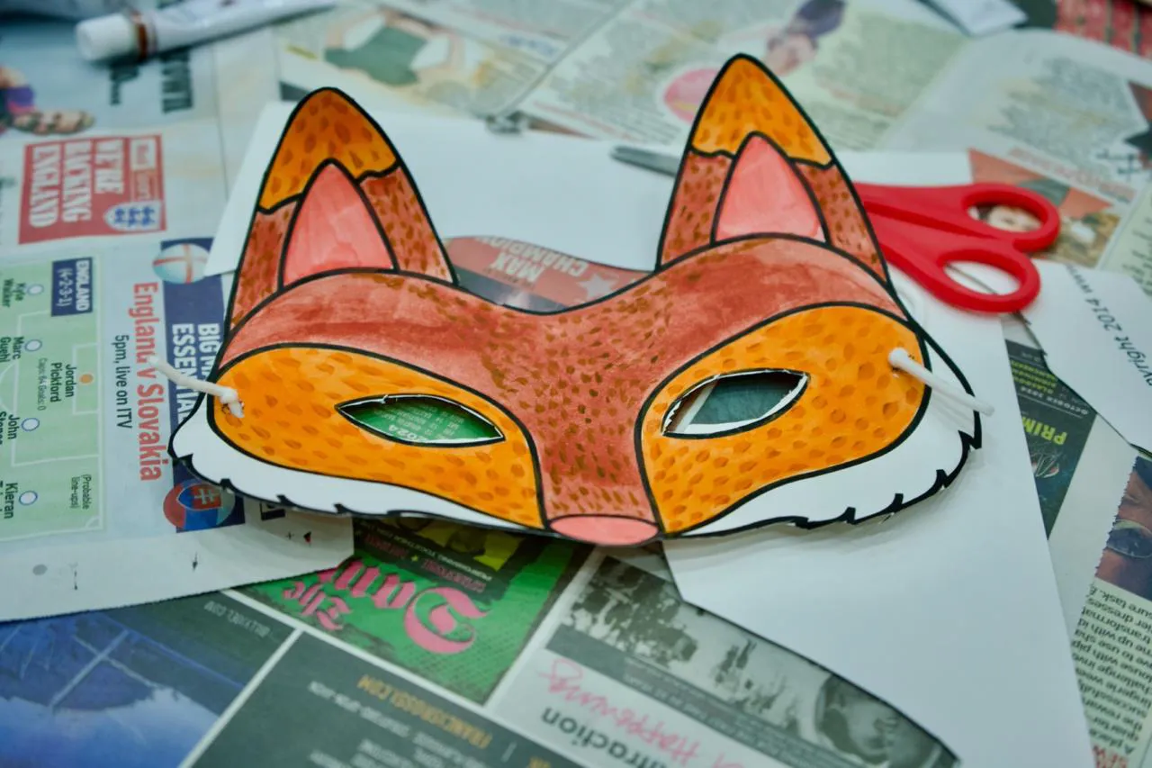 A colourful fox mask on a school table