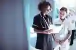 Two nurses reading from a clipboard